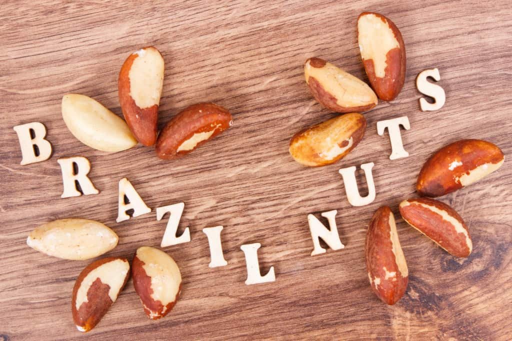 Inscription brazil nuts and fruits containing natural minerals and vitamin