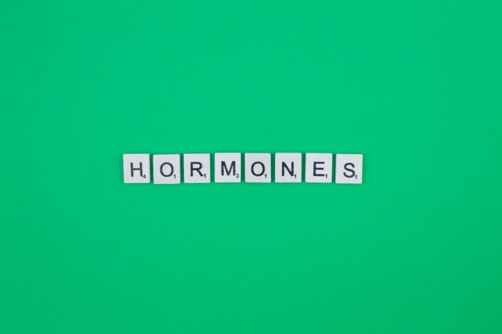 Hormones- scrabble letters word on a green background